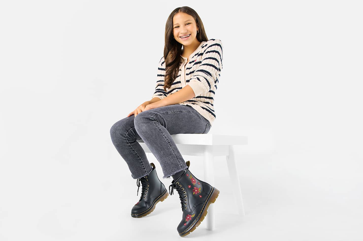 An adult kid wearing stylish lace-up boots