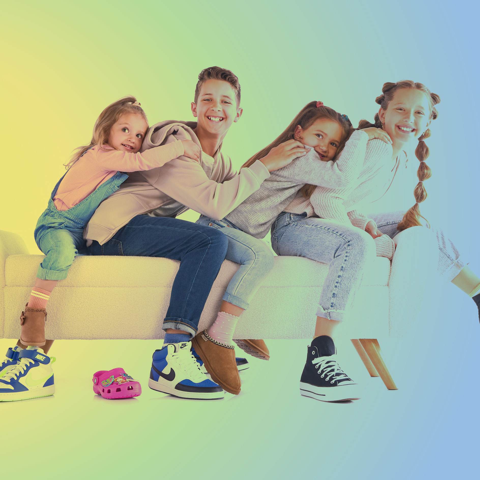 A mom, dad and their young daughter jumping for joy while wearing trendy and comfy athletic sneakers.