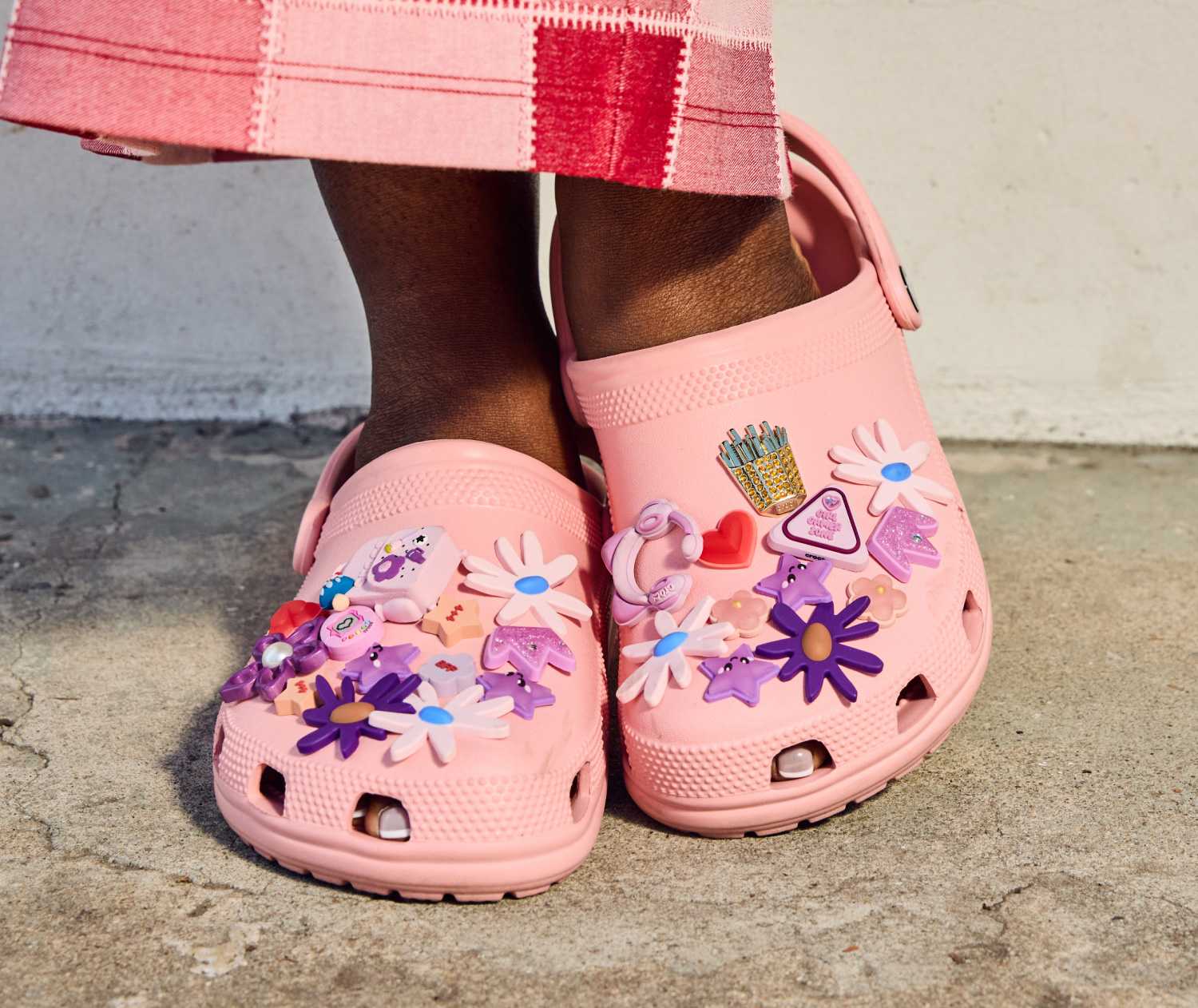womens fuzzy crocs classic clog walking on sidewalk.
