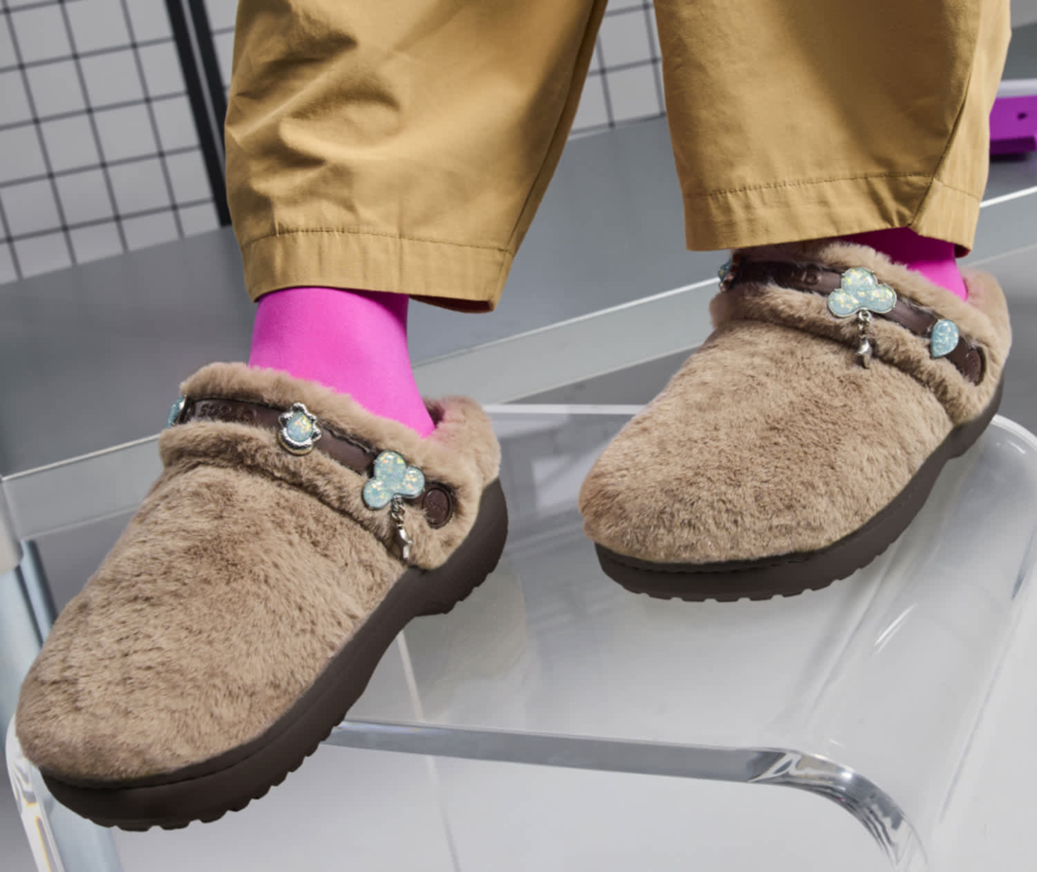 womens fuzzy crocs classic clog walking on sidewalk.