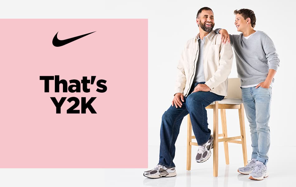 A Dad sitting on a stool wearing Men's Nike V5 RNR Sneaker with his son standing next to him also wearing a Nike Men's V5 RNR Sneaker.	