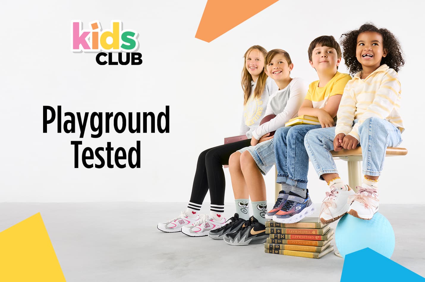 Kids branded sneakers in six different styles are placed on the floor next to each other
