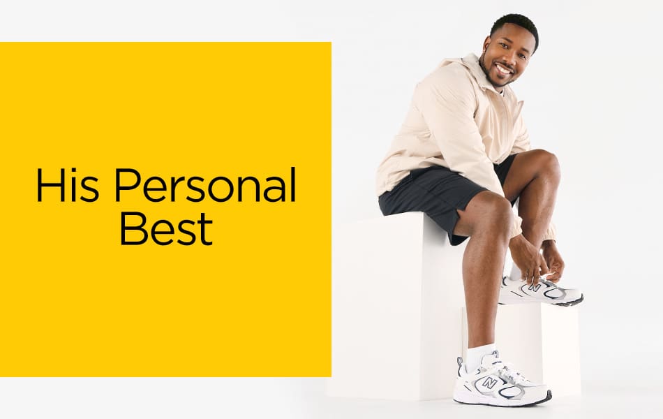 An active dad getting his New Balance sneakers all tied up while sitting on a white plinth.