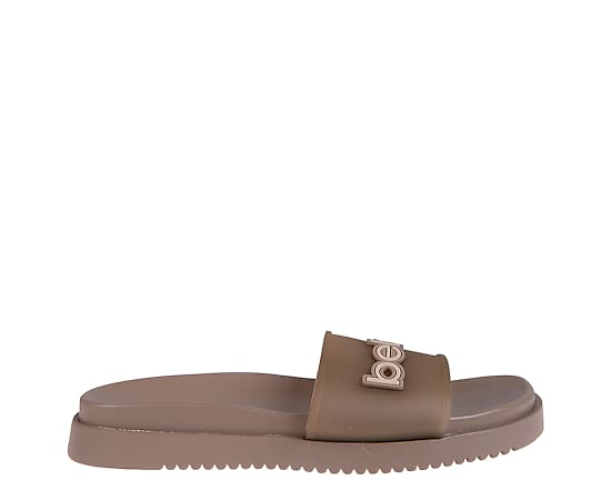 bebe Women's Sandal with Translucent Upper and Rubber Logo Patch - Tan